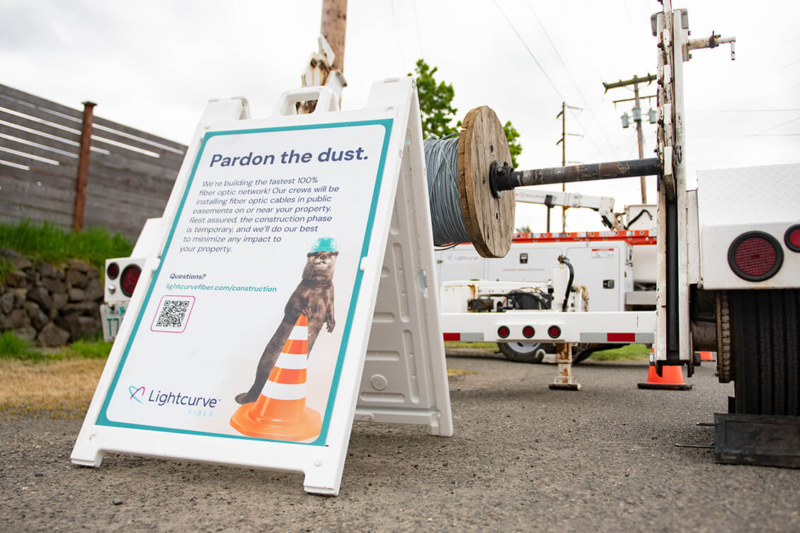 Lightcurve-branded sandwich board at work site.